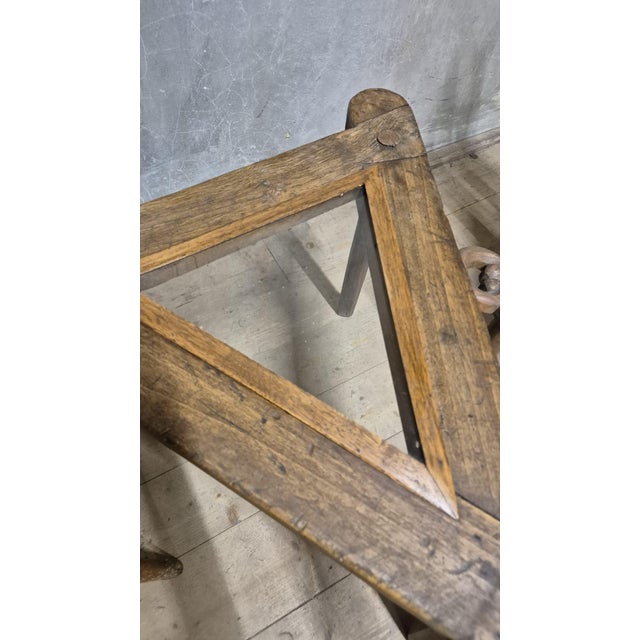 A distinctive vintage wooden table and chair set featuring sculptural, handcrafted forms and striking decorative details....