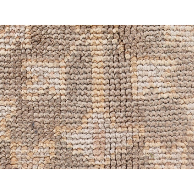 This exquisite antique Turkish Oushak rug from the early 1900s measures approximately 17 feet by 14 feet and is a stunning...