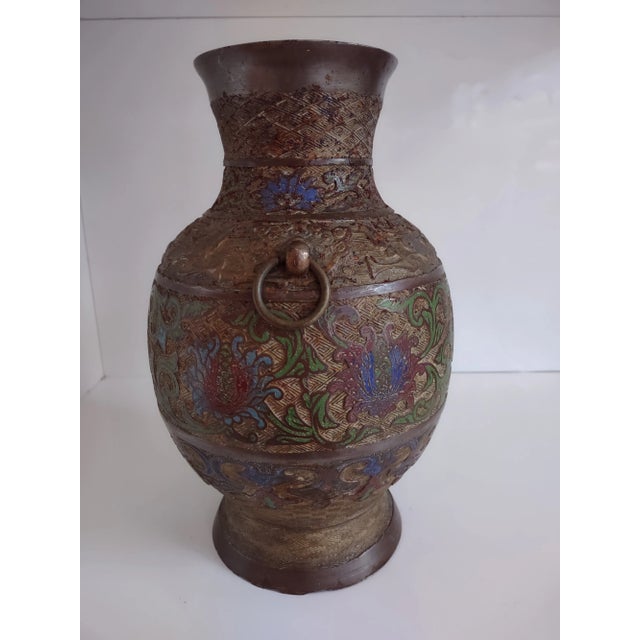 An absolutely stunning Japanese champlevé bronze vase from the early 1900s, featuring an urn form with a very intricate...