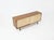 A two-door sliding sideboard lined with canvas, featuring leather handles and metal legs. One side has an adjustable...