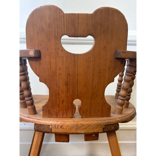Late 20th century Hand carved charming folk art meets primitive structure. Aged pine featuring. This chair has turned...