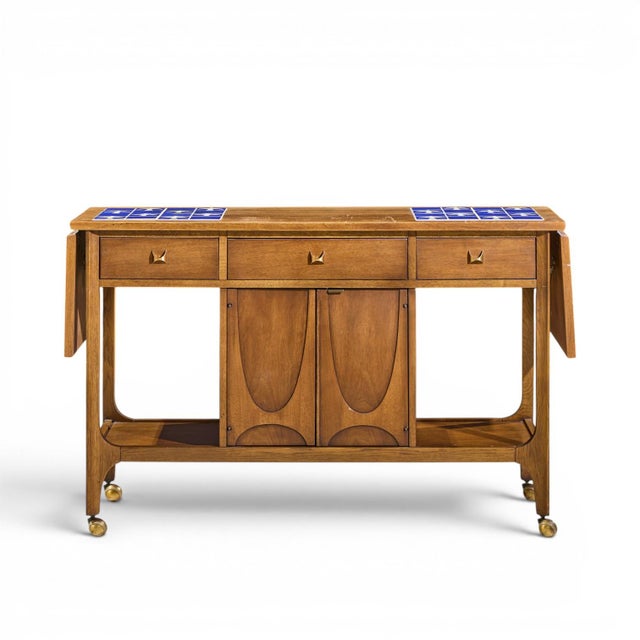 Broyhill Brasilia Mid Century Walnut Bird Tiles Bar Cart This bar cart measures: 47.25 wide x 16.25 deep x 30 high, when...
