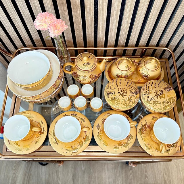 Tone‑on‑tone gilding distinguishes this porcelain tea service by Gold Lion (the underside bears the katakana mark “Golden...