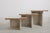 A vintage set of three solid two tone fossil marble nesting tables with natural shell inclusions, cream and grey-veined...