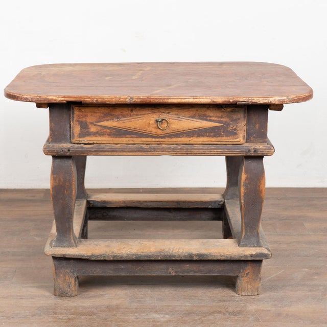 19th century Swedish Baroque side table, crafted in pine and retaining its original painted finish. The base shows...