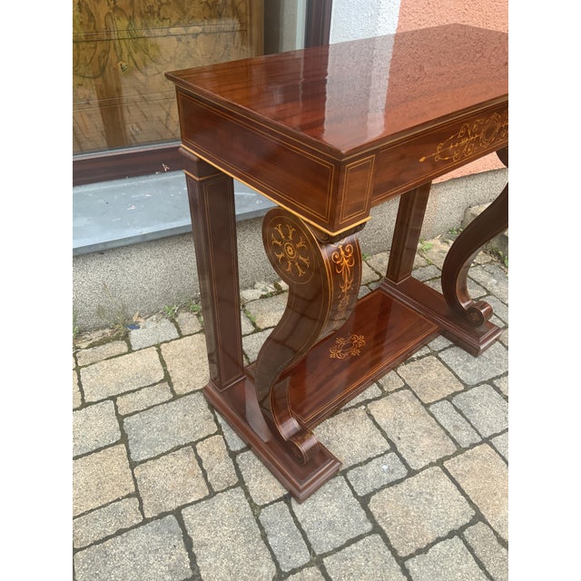 Elegant console with frame box, in the middle the drawer, box rests on frame and in the front on volutes, richly inlaid,...