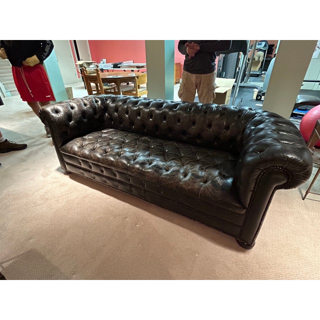 Sensational vintage tufted black leather large classic Chesterfield sofa having enviable distressing on the seat,...