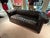 Sensational vintage tufted black leather large classic Chesterfield sofa having enviable distressing on the seat,...
