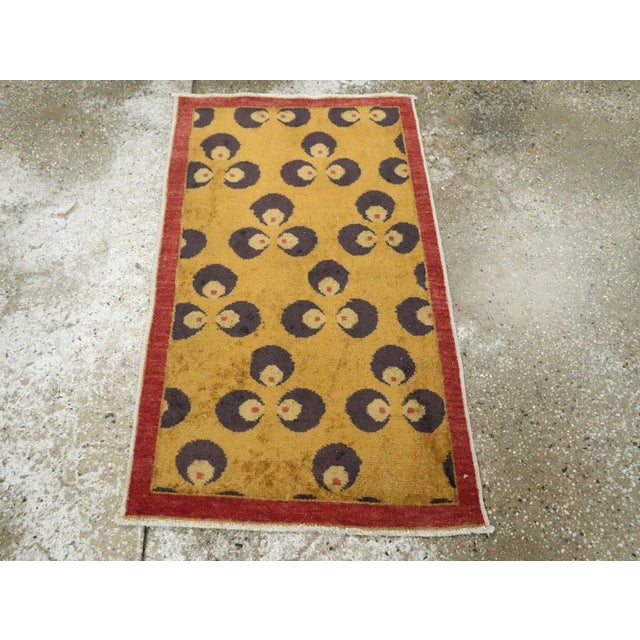 This Mid-20th century Turkish Art Deco throw rug, measuring 2' 0" x 3' 3", embodies the bold yet minimalist aesthetic of...