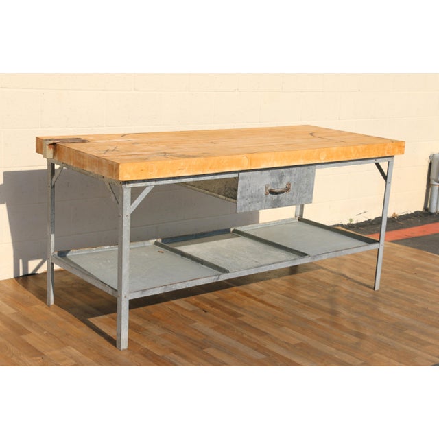 Authentic 1950s industrial butcher block workstation table featuring a substantial solid wood top mounted to a galvanized...