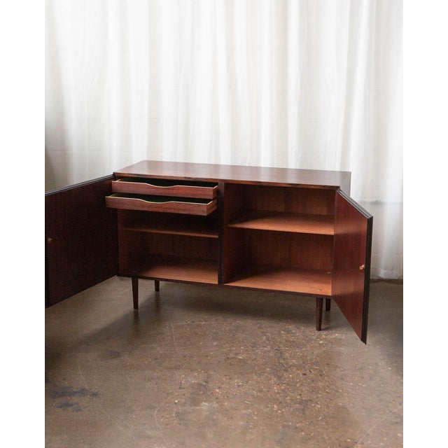 A refined example of Danish Modern cabinetry by Omann Jun, executed in richly grained rosewood during the height of...