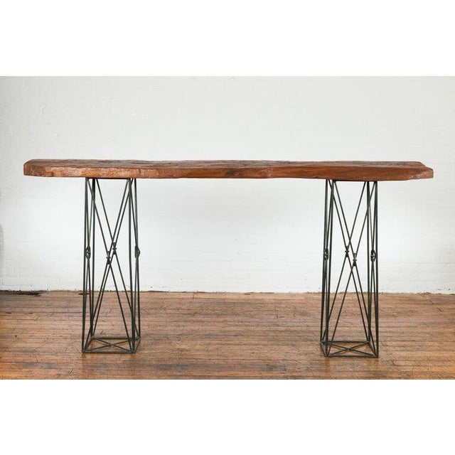 A unique contemporary console table made with a Javanese reclaimed wood top and two metal suspension bases from Thailand,...