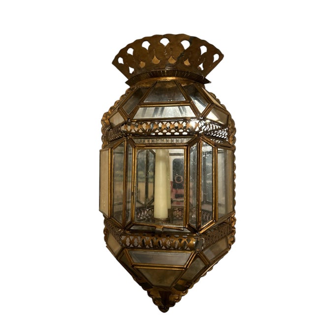 Fabulous ethnic looking candle sconce. It has multiple angles of glass he'd together with metal. It has a nice diamond...