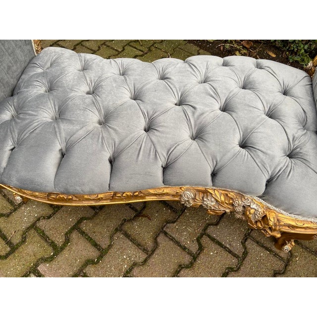 This elegant late 20th-century French Louis XVI–style settee combines sculptural carved decoration with soft gray velvet...