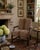 A handsome late 20th-century English Chippendale-style armchair crafted in richly toned mahogany and upholstered in a...