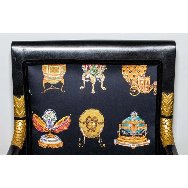 Charming mid century modern black chair with gilt swan decoration on the arms. Upholstered in a Faberge-style fabric with...