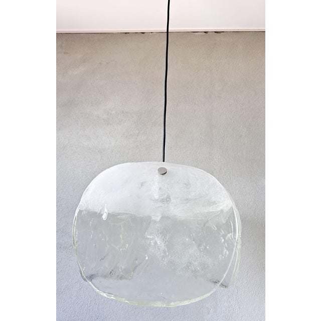 Bring a touch of vintage charm into your home with this beautiful Kalmar pendant lamp. The unique glass design creates a...