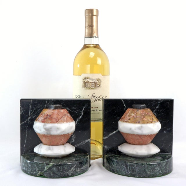 A very heavy pair of bookends with geometric shapes and contrasting colors of creamy alabaster and red and green marble....