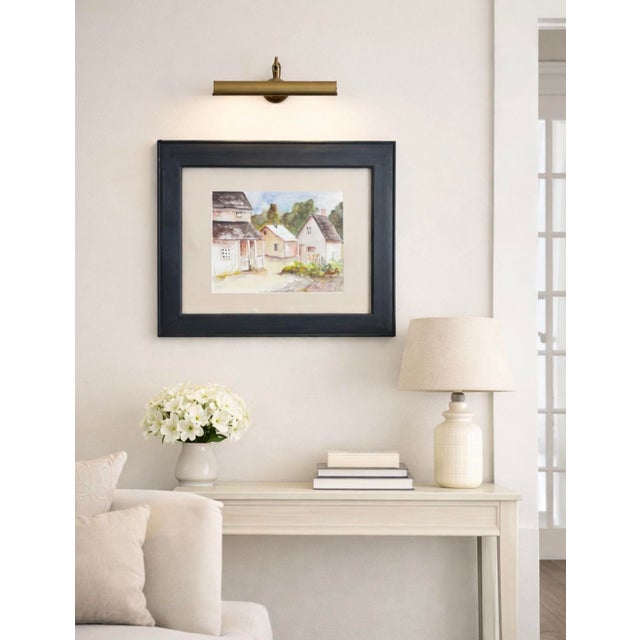 Original watercolor painting depicting a charming European village cottage scene with gardens and rustic architecture....