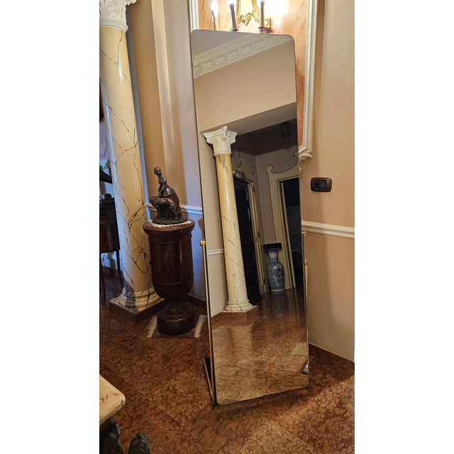 Soft, sinuous shapes for a frameless mirror that reflects dreams and the sky. Supported by two brass uprights that allow...