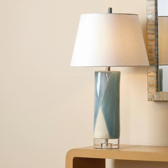A wonderful feeling of calm is evoked in this enchanting table lamp. The handcrafted ceramic body seems to float above its...