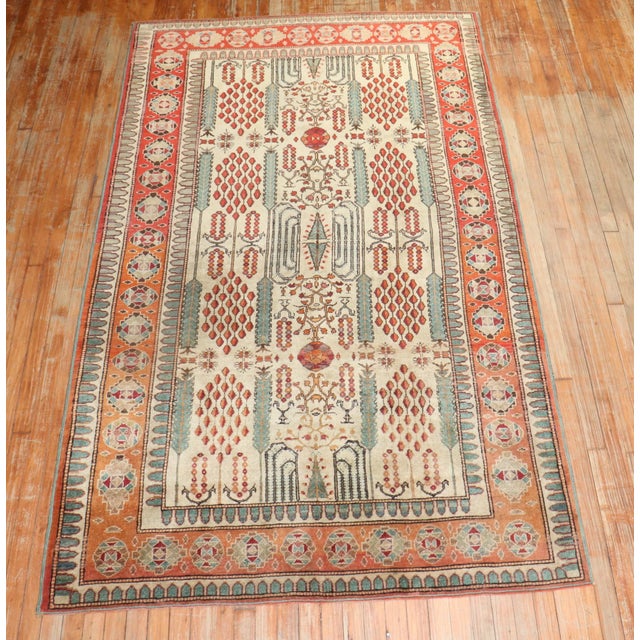 West Turkish Rug with a cypress tree design in orange, apricot, and green on a khaki field from the early 20th Century
