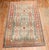 West Turkish Rug with a cypress tree design in orange, apricot, and green on a khaki field from the early 20th Century