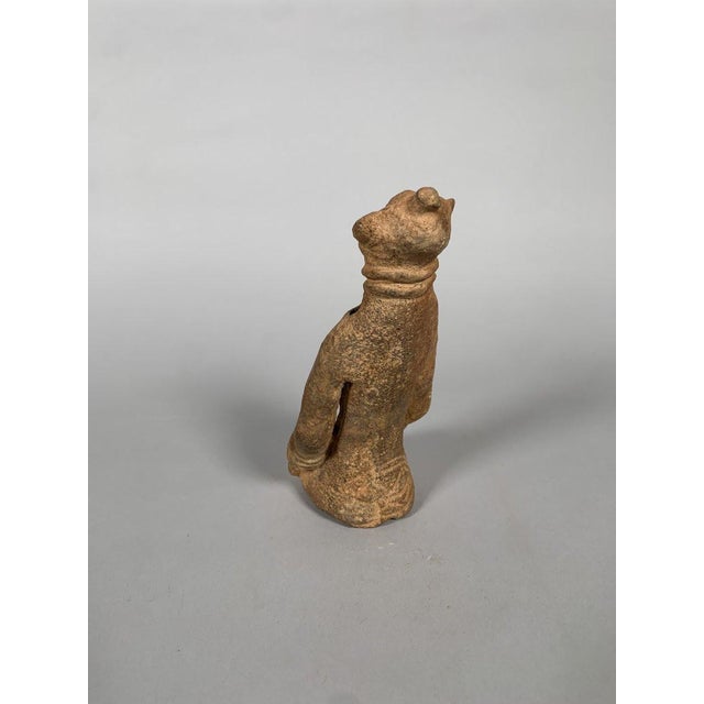 Bankoni statuette, Mali, 13th-15th century, red ochre terracotta. The statuette represents a seated female figure, her...