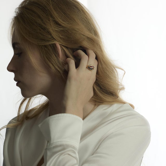 This vintage 1980’s cocktail ring is crafted in 18k yellow gold and set with vibrant baguette cut rubies and sapphires,...