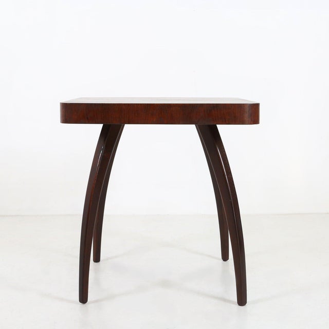 This Art Deco coffee table known as the "spider table" (Model H259) was designed by Jindrich Halabala and is produced by...
