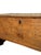 A rustic 19th-century fir wood chest, characterized by richly detailed craftsmanship and engraved decorations that testify...