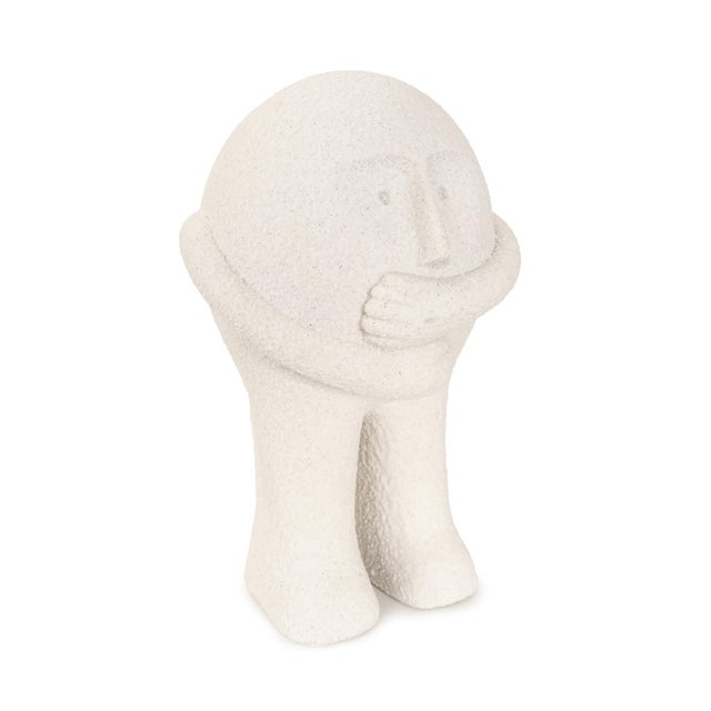 Finished in a soft matte white with a subtly textured surface, its minimalist form and expressive stance make it a...