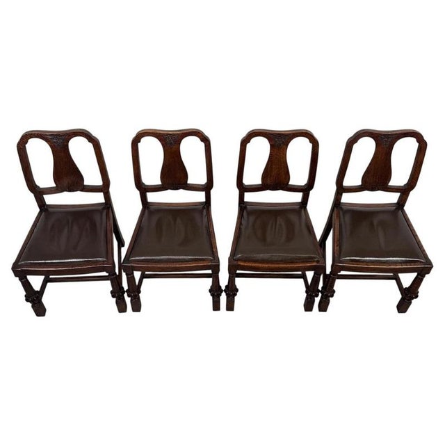 A handsome early 20th-century English Edwardian set of four dining chairs, finely crafted from oak and distinguished by...
