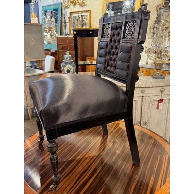 The antique Century English Chinoiserie Vanity Chair is a luxurious and ornate piece of furniture. This chair, featuring...