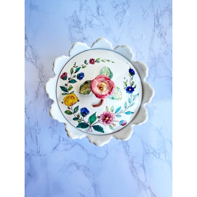 This lidded dish will add rustic European charm to any space. We especially love the flower handle on the lid and...