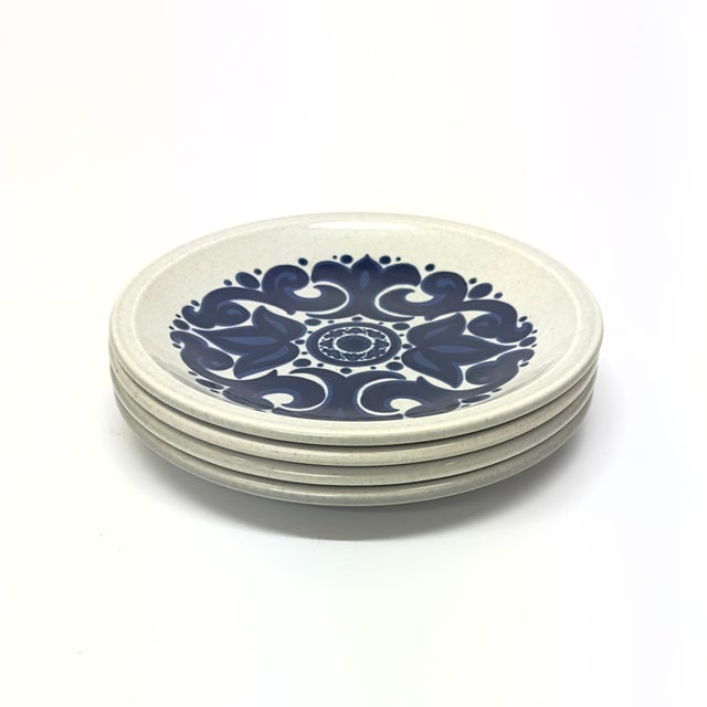 White and blue side plates, group of 4. This set of four ceramic bread plates were crafted by Wedgwood in England, during...
