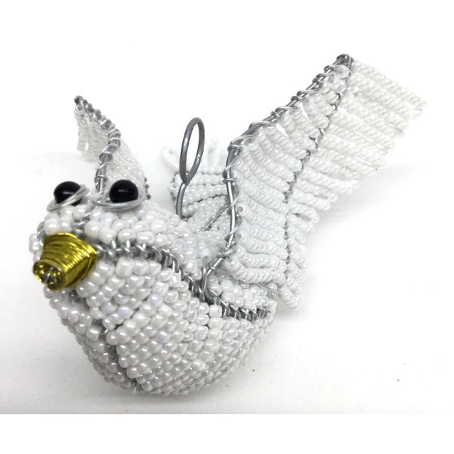 Delicate white glass beads have been woven over silver tone wire to create a gorgeous heavy and sturdy hanging dove. Use...
