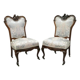 Early 20th Century Victorian Floral Scrollwork Carved Mahogany Parlor Slipper Side Chairs - A Pair For Sale