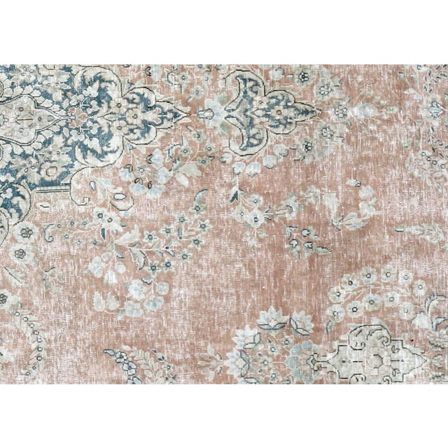 This vintage Persian Kerman rug, measuring 9'8" x 13'10", is handwoven in Iran's Kerman region and has been carefully...