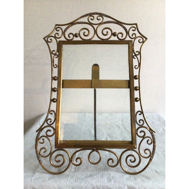 This 1900s English Brass Scrolled Picture Frame features C-scroll corners that are embossed with more intricate patterning...