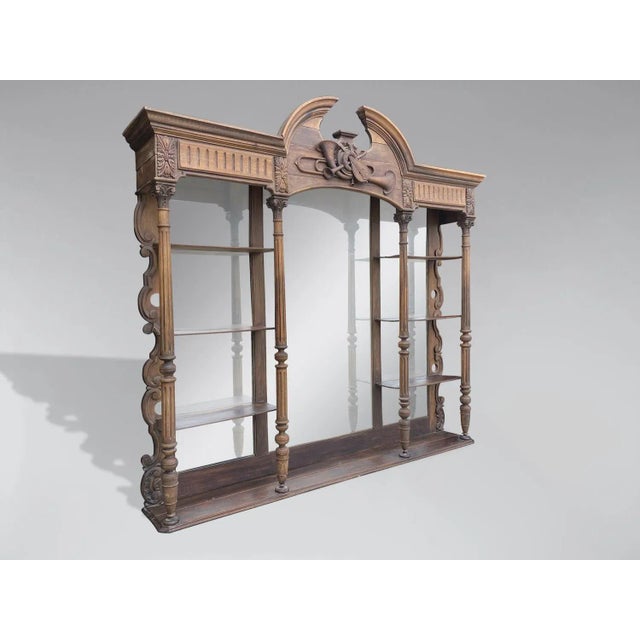 A very decorative large 19th-century French carved and ornate walnut back bar shelving unit or étagère. It features a...