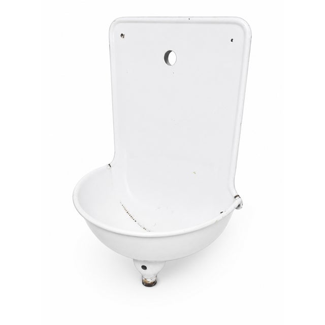 This striking wall-mounted enamel sink is a sculptural mid-century architectural object originating from Central Europe in...