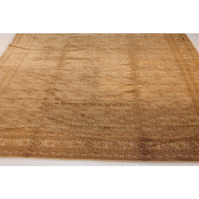 An early 20th century Persian Tabriz rug, the sand field with a faint herati pattern overall within a sand rosette and...