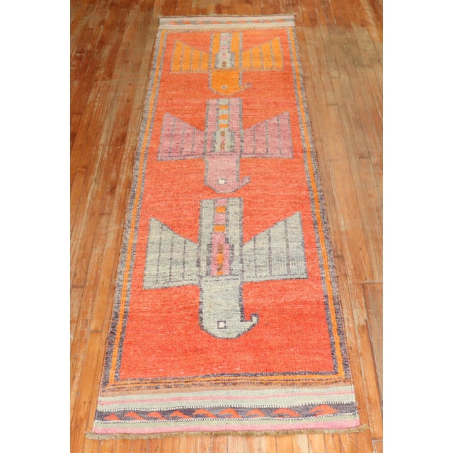 Runner size mid 20th-century Turkish Anatolian rug with a pigeon pattern on an orange field