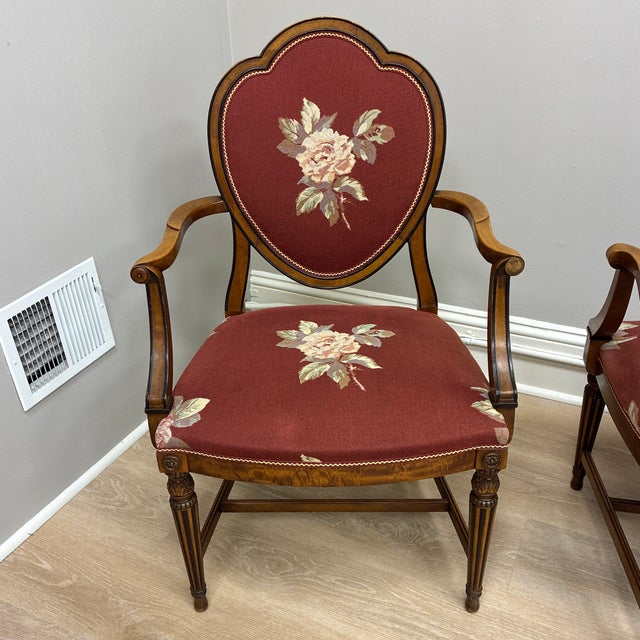 Adorable rose embroidered armchairs with green and mauve checkered background and matching trim.