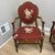 Adorable rose embroidered armchairs with green and mauve checkered background and matching trim.