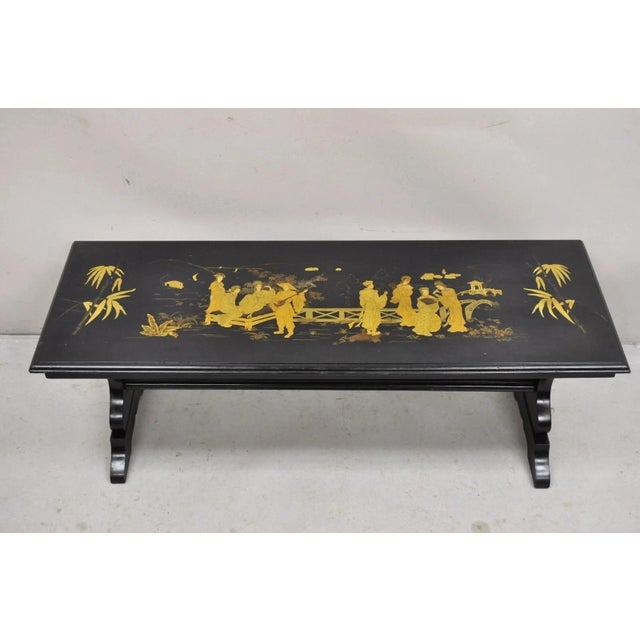 Vintage Chinoiserie Oriental Black Lacquer Gold Gilt Trestle Bench Coffee Table Circa Early 20th Century. Measurements:...