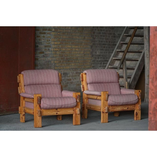 A lovely pair of lounge chairs in solid pomeranian pine, with cushions upholstered in a textured wool-blend fabric...