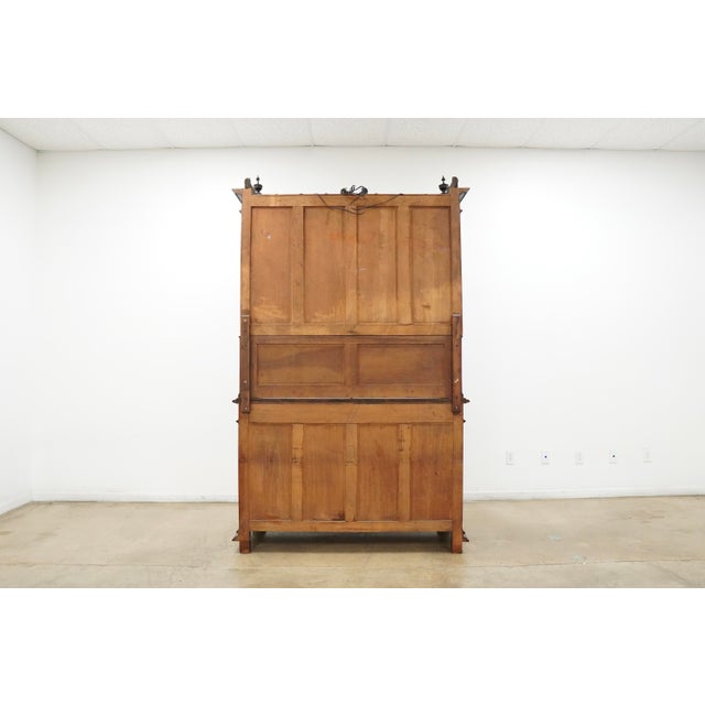 Vintage Gothic Revival style hutch cabinet with dramatic carved detailing throughout. This substantial two-piece cabinet...