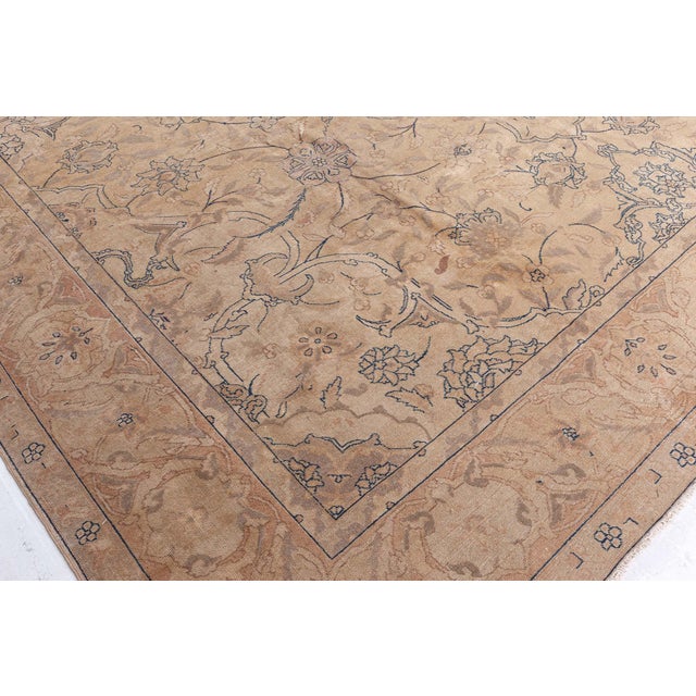 A late 19th century Persian Tabriz rug, the caramel field with a subtle allover lattice of flowering vinery and palmettes...